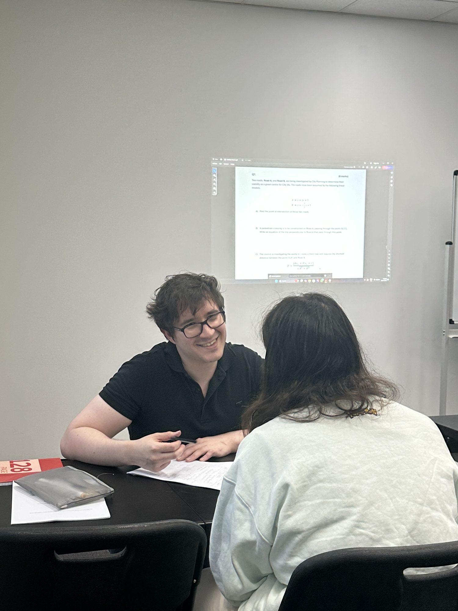 Spartan Tuition co-founder Adrian talking with a student in a class