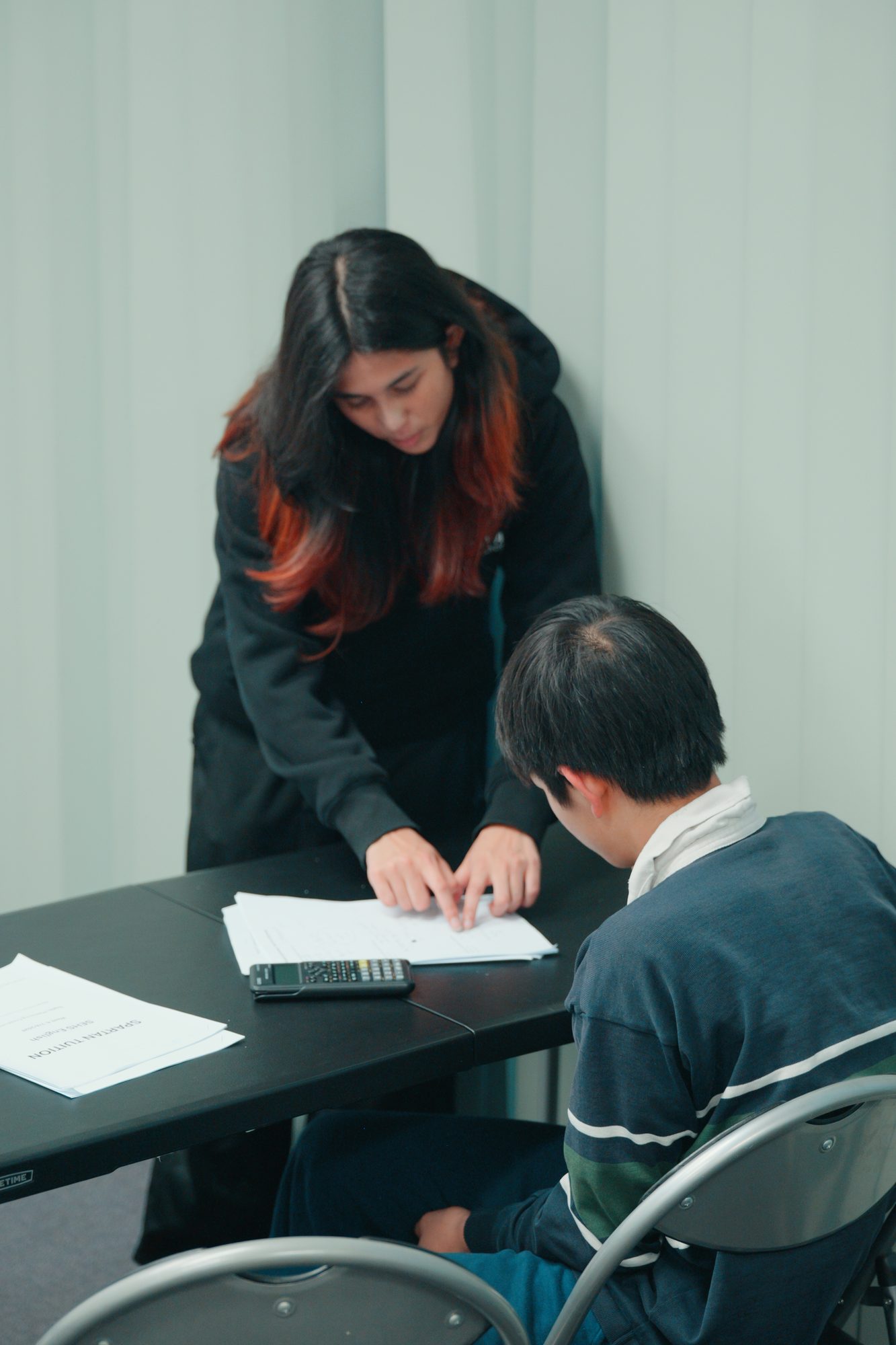 A Spartan Tuition tutor helping a student through a problem