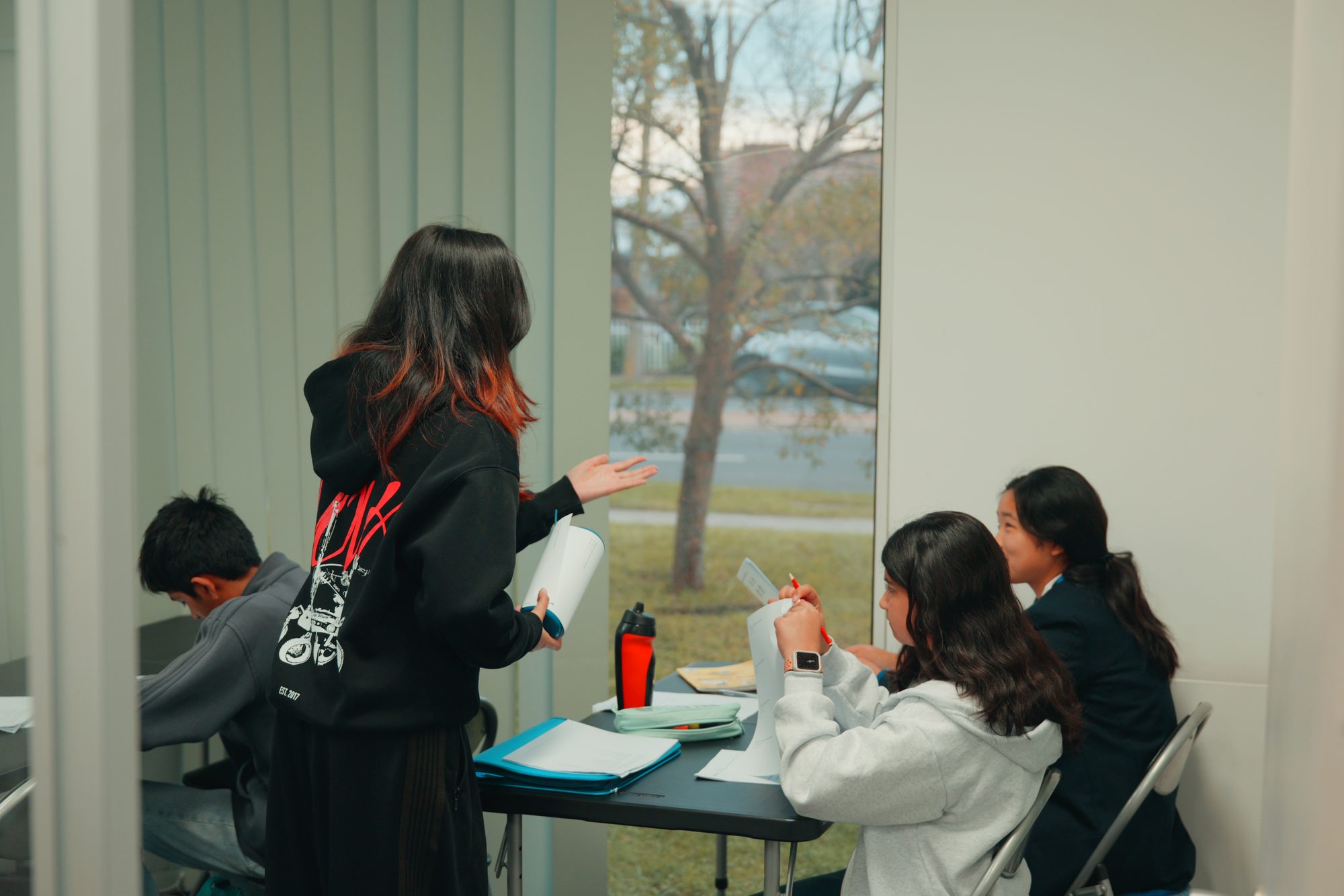A Spartan Tuition tutor talking with students during a class