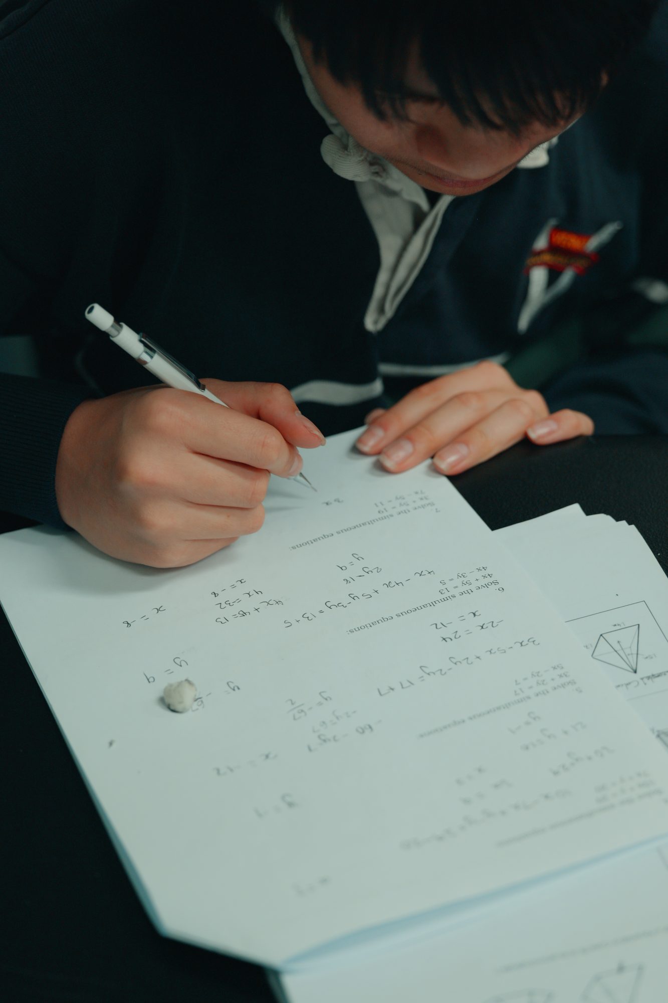 A student working through simultaneous equations in a Spartan Tuition class