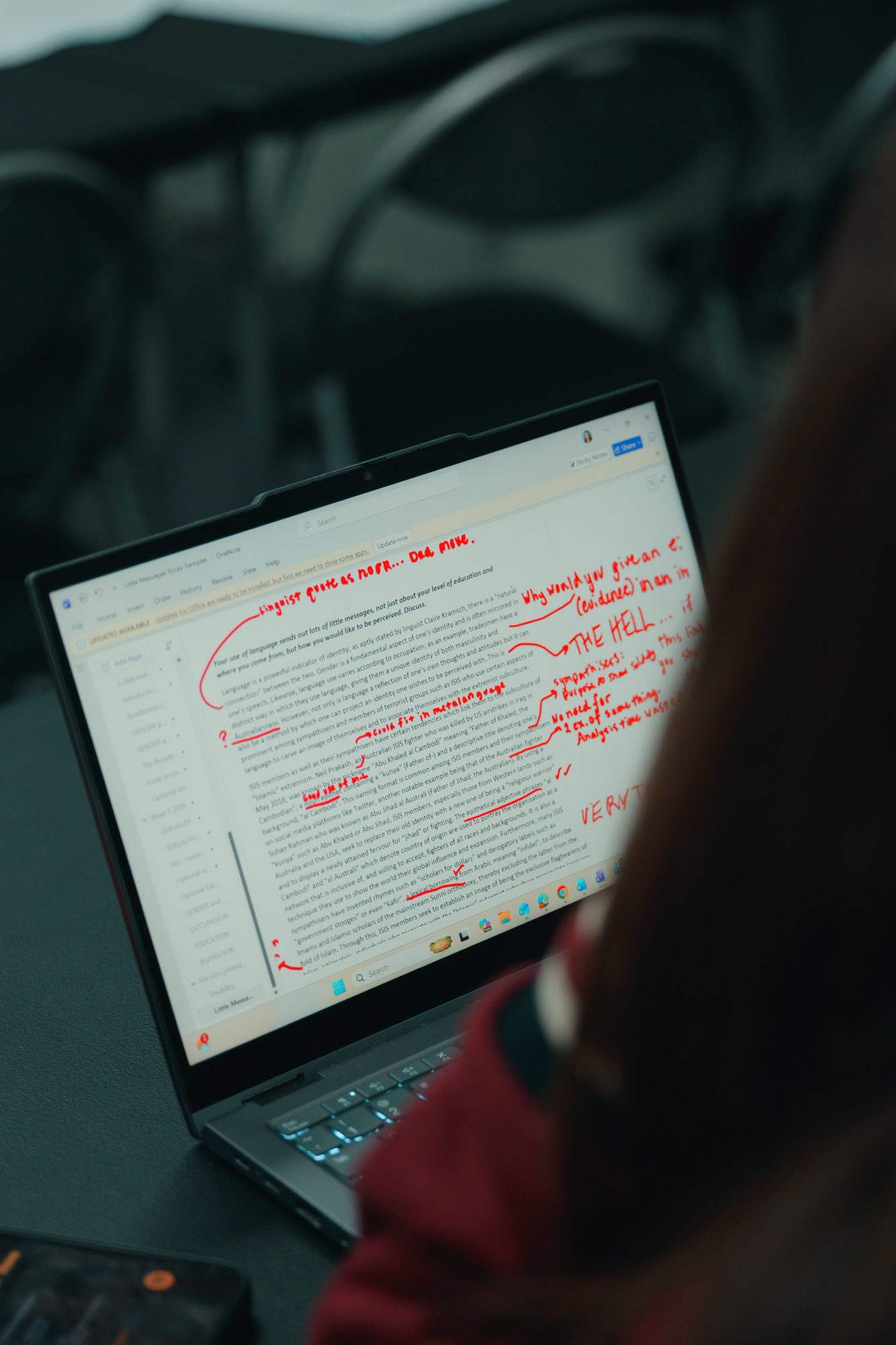 A student's practice essay marked up with feedback