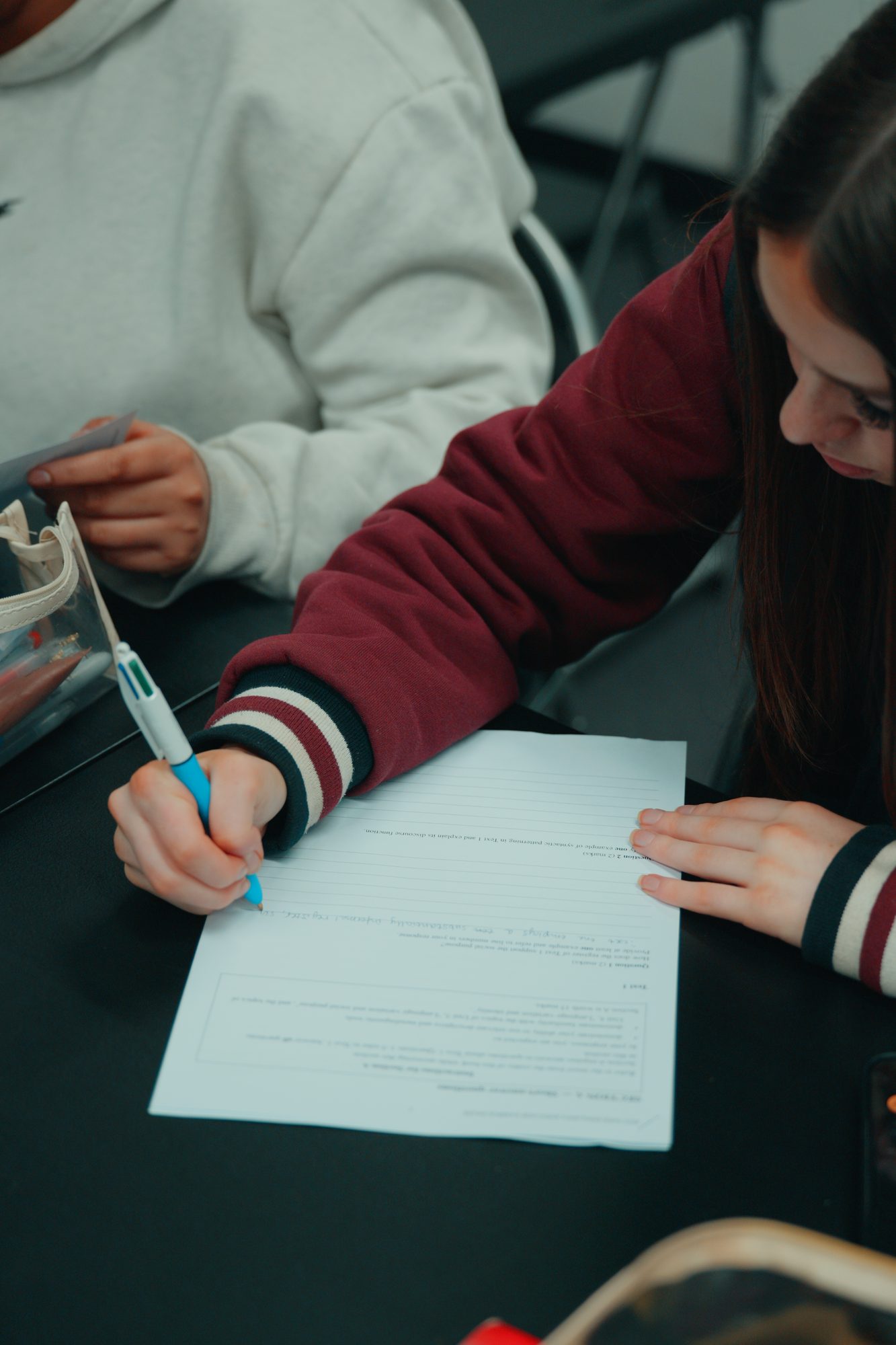 A student writing answers during a Spartan Tuition class